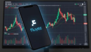Smartphone con el logotipo de Fluyez en la pantalla y graficos de criptomonedas detrás