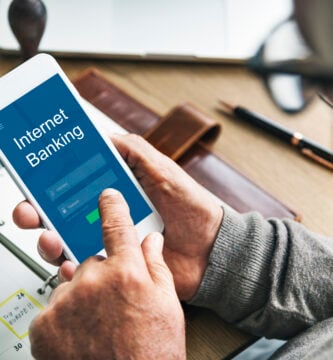 persona con smartphone entra en un aplicacion del banco. Como comprar criptomonedas en bbva